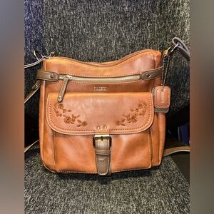 Rosetti brown crossbody bag featuring floral embroidery on the front flap